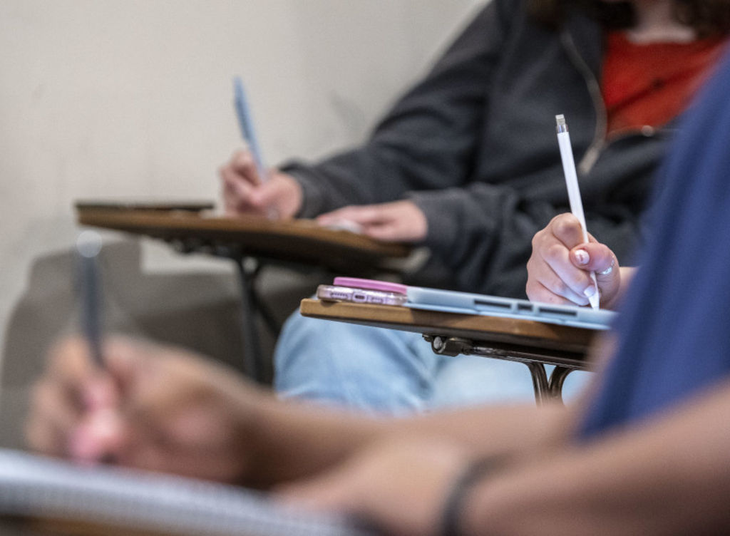 students writing notes in a classroom